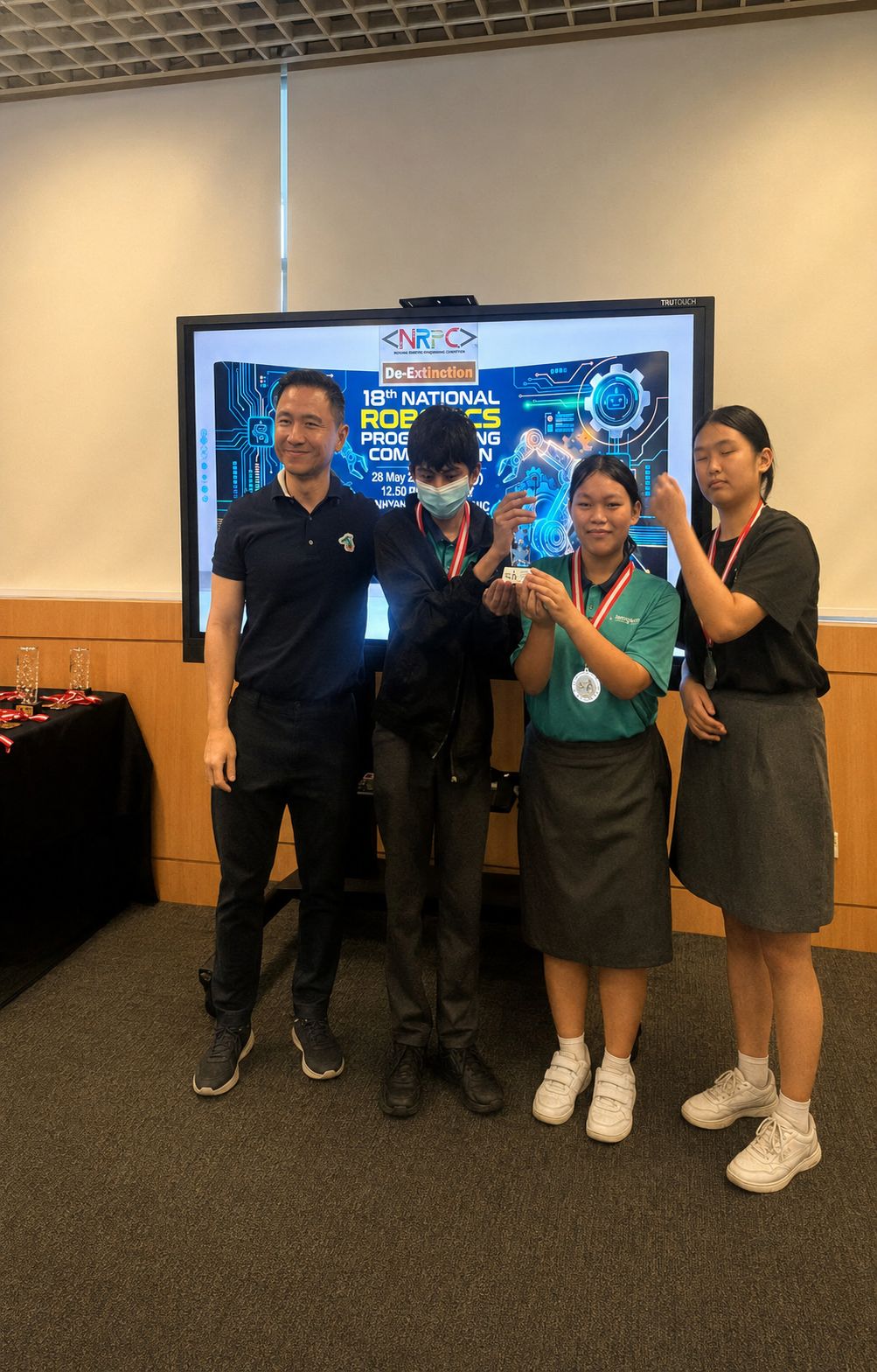 3 students with medal stand next to a man with a black shirt